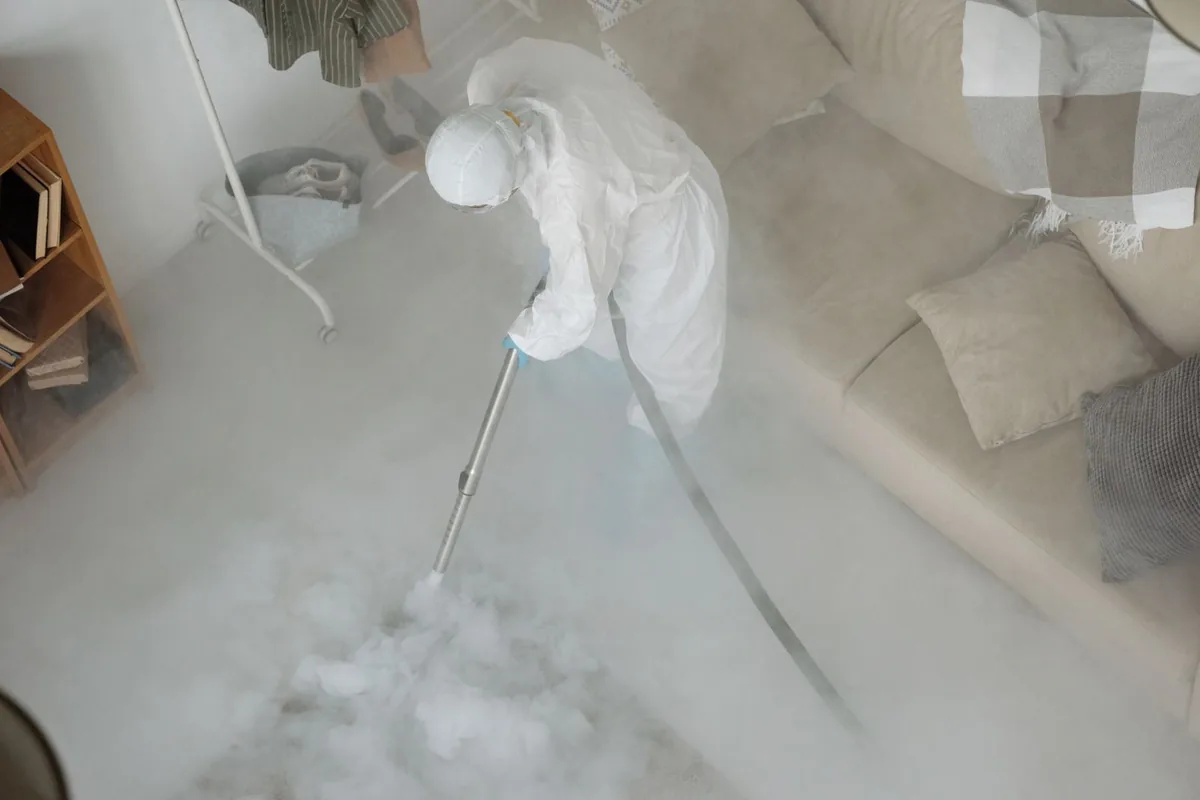 Biohazard cleanup technician in protective equipment, Vance, AL